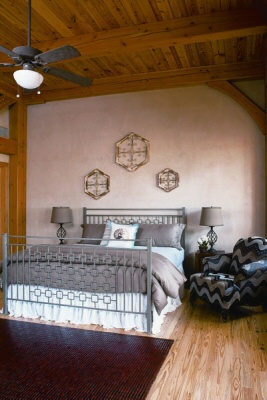 The spacious second-floor guest bedroom is brightened by windows that look to the marsh and boats cruising to the ocean. Overhead, the heart-pine ceilings are the sub-flooring for the third story.